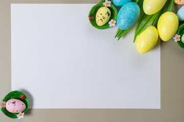 Creative easter flatlay with white paper blank
