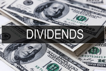 Background of dollar bills with word DIVIDENDS