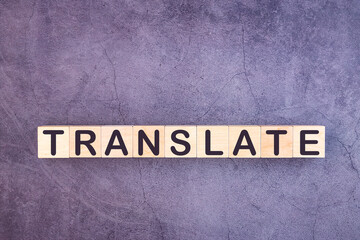 TRANSLATE word made with wood building blocks.