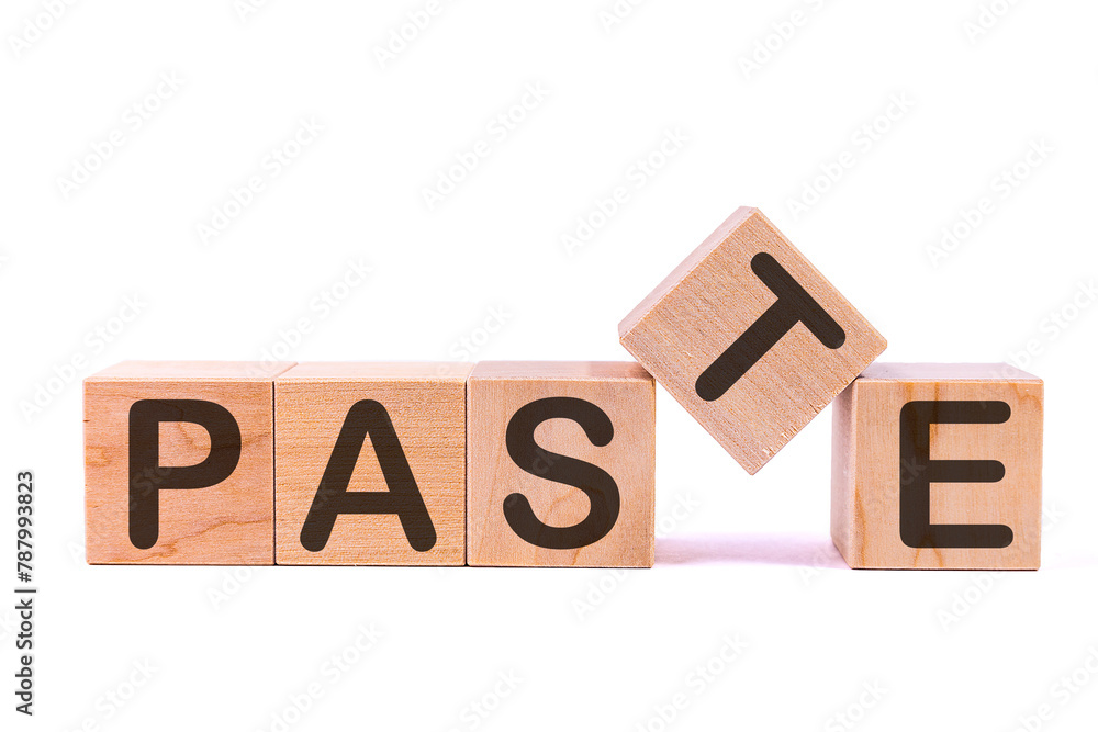 Fototapete word paste is made of wooden building blocks lying on the table and on a light background. concept.