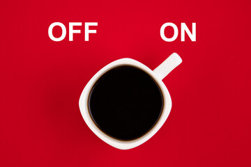 A white cup of coffee is turned on. Concept on a red background.