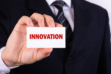 IBusinessman holding a card with text innovation
