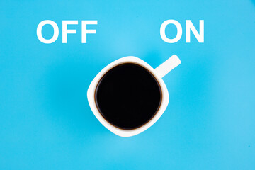 A white cup of coffee is turned on. Concept on a blue background.