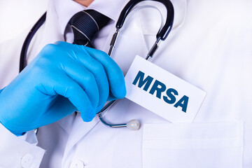 Doctor, man put a card with the text MRSA in his pocket. Medical concept.