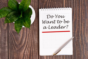 Do You Want to be a Leader - handwriting on a notebook with pen and a cup of coffee