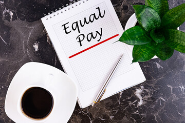 Equal Pay - handwriting on a notebook with pen and a cup of coffee
