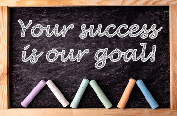 Chalkboard and color chalks with text Your success is our goal.