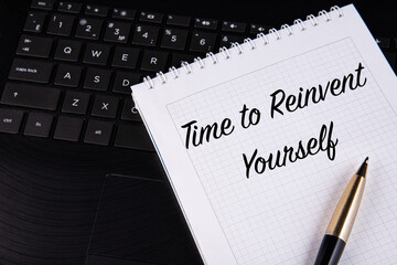 Time to Reinvent Yourself - written on a notebook with a pen.