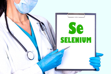 Se SELENIUM text is written on a tablet that is held by a doctor in medical clothes and disposable...