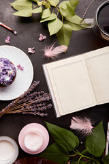 Feminine aesthetics lifestyle. Open notebook mockup among cup of coffee, purple floral cupcake,...