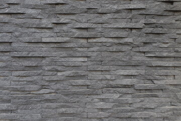 Neat abstract shapes and patterns of natural stone walls. Rectangular natural stone. House walls covered with natural stone for aesthetics. For graphic design and background