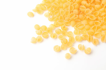 Shell shaped pasta on white background. Uncooked, dry conchiglie macaroni