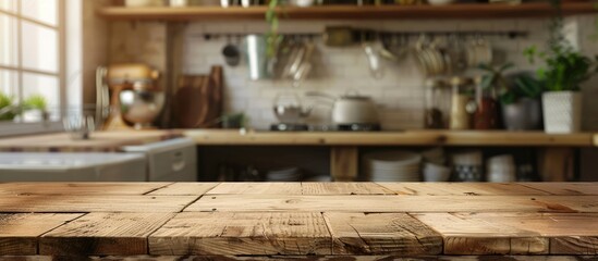 A wooden table without any items on it, set against a blurred background of kitchen accessories, with space for adding text. - obrazy, fototapety, plakaty