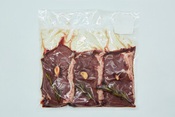 Pickled meat with spices in vacuum packaging on a white background. Different parts of meat products for different dishes. - 788029071