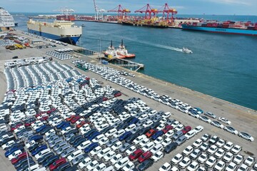 Aerial view of port with new electric vehicles awaiting delivery