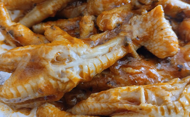 Chicken feet casserole in sauce