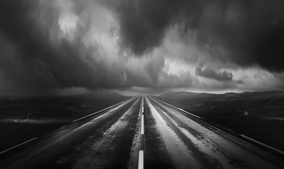 Foto op Canvas An empty road in the middle of the field in the style of boldly black and white, An empty highway with a dark sky in the background   © iqra