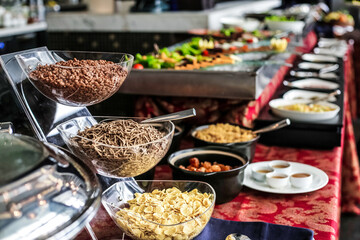 Buffet Line With Cereal Bowls and Assorted Foods