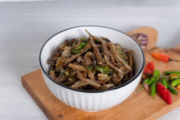 Green chili anchovies, typical Indonesian food. served in a small bowl.