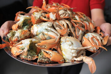 Fresh crabs are placed in a large container and ready to be cooked
