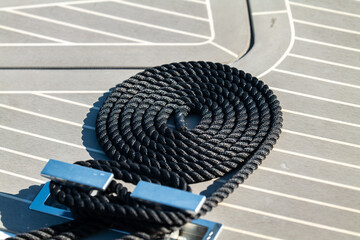 The bow of a beautiful powerboat with nice clean lines showing the dock rope.