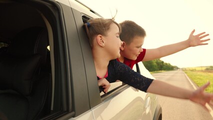 boy girl looking out car window, child kid boy girl waving hand, picturesque evening road, children...