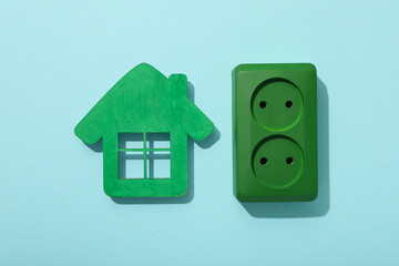 Decorative house with a green electrical outlet