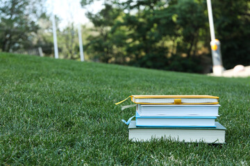 Books on the grass in the park