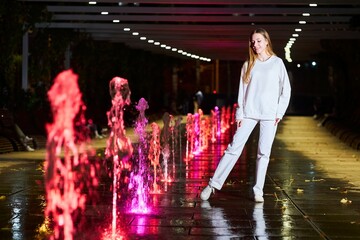 Beautiful young girl in white clothes at night in the park. - 788046475