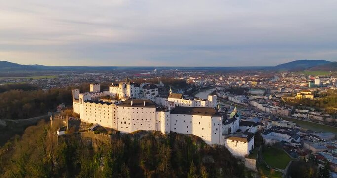 Aerial view Hohensalzburg Castle in Salzburg Austria. A fortress on top of a mountain in the cityscape of a European city in the nature of alpine mountains. High quality 4k footage