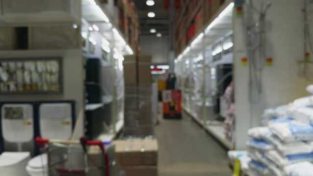 Blurry image of a crowded warehouse with shelves full of boxes