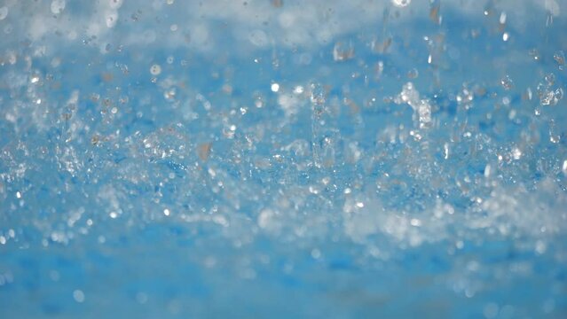 Water drops falling on the water caustic surface in 4k slow motion 120fps