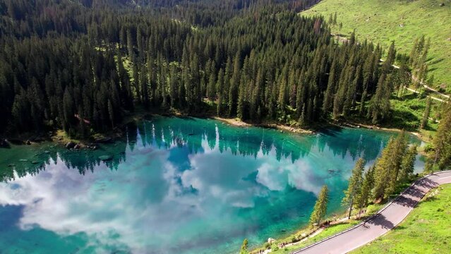 Italy Idyllic nature scenery- trasparent mountain lake Carezza surrounded by Dolomites rocks- one of the most beautiful lakes of Alps. South Tyrol region. 