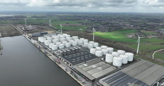 Aerial drone view of a tank terminal in Ghent, Belgium, focusing on the storage, distribution, and handling of dry and liquid bulk cargo, freight forwarding, and warehousing.