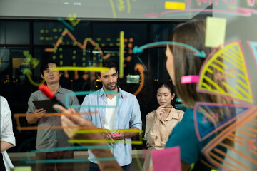 Group of smart diverse businesspeople brainstorming business strategy. Young female leader sharing, explaining, designing business idea at night office. Business planing, Working together. Tracery.