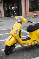 Bright yellow classic scooter - traditional transport of Italy
