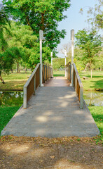 Park Footbridge with Lamp Posts and Greenery.