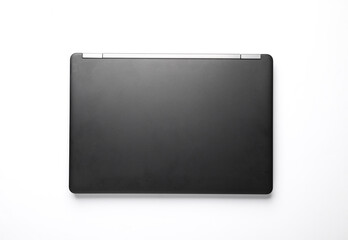 Black closed laptop or ultrabook on a white background. Top view