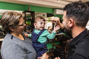Child's first haircut at barbershop