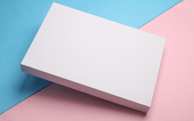 White cardboard box on blue pink pastel background