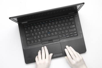 Artificial intelligence. Plastic hands typing on laptop