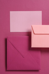Set of floating pink tones envelopes and card on pink  background. Invitations, corporate...