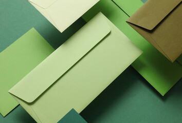 Set of floating green tones envelopes and cards on green  background. Invitations, corporate...