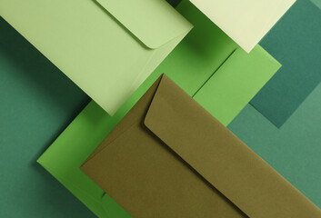 Set of floating green tones envelopes and cards on green  background. Invitations, corporate...
