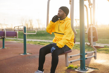 Man having phone conversation while taking outdoor workout break