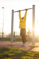 Man doing pull ups while working out outdoors