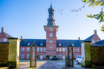 Castle of Husum, Germany in the morning with clear sky, horizontal view with entrance fence in front, low angle view - Powered by Adobe