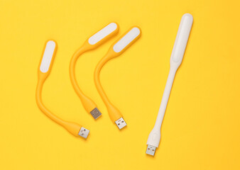 Flexible USB lamps on yellow background. Top view