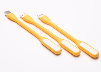 Flexible yellow USB lamps on white background.