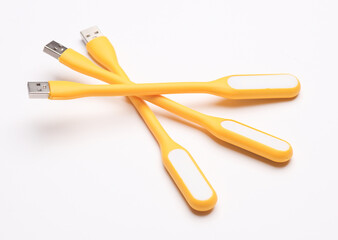 Flexible yellow USB lamps on white background.